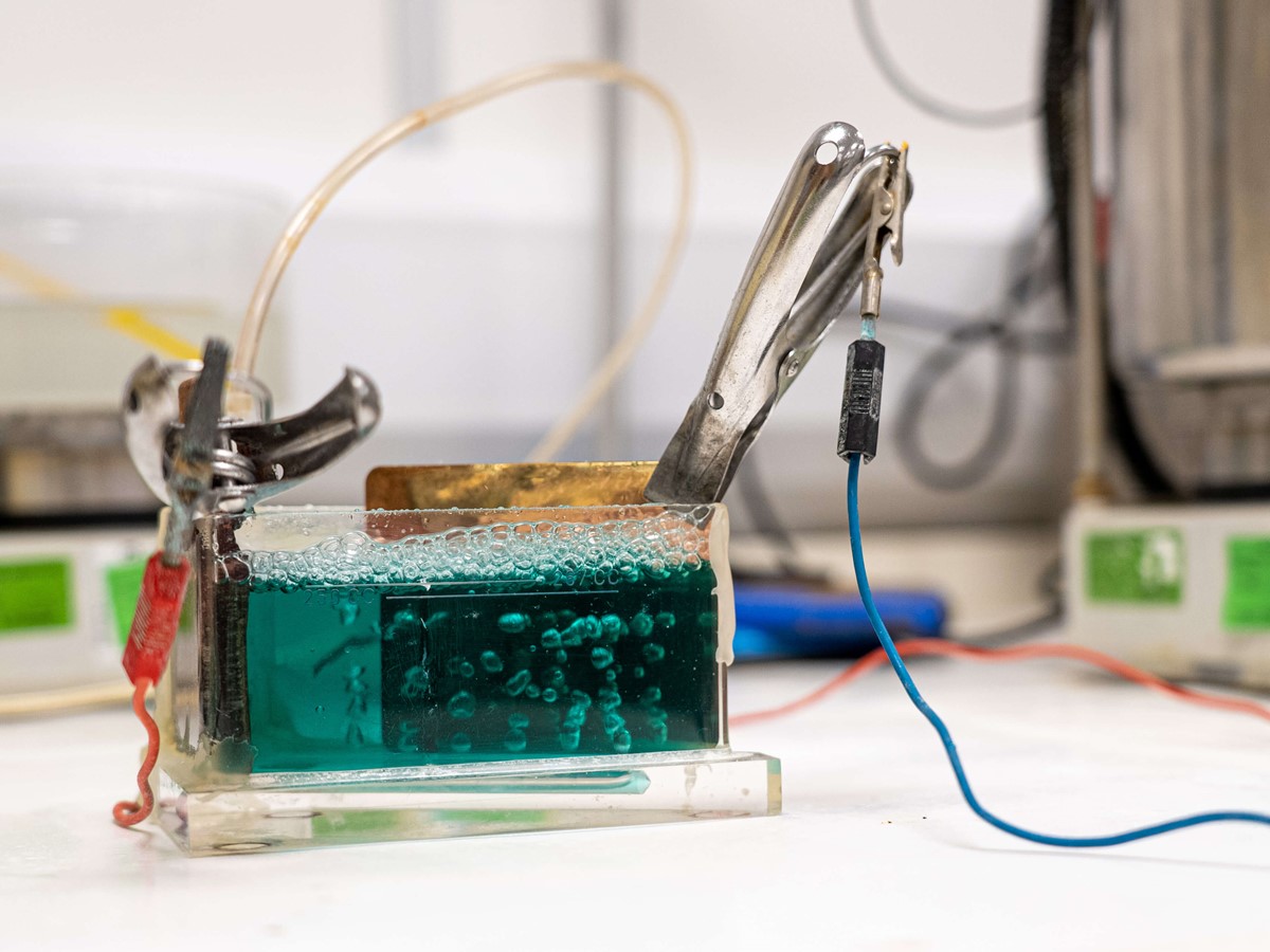 Plastic container filled with green liquid and equipment