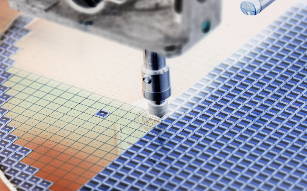 A mechanical needle filling in squares of blue etched ink